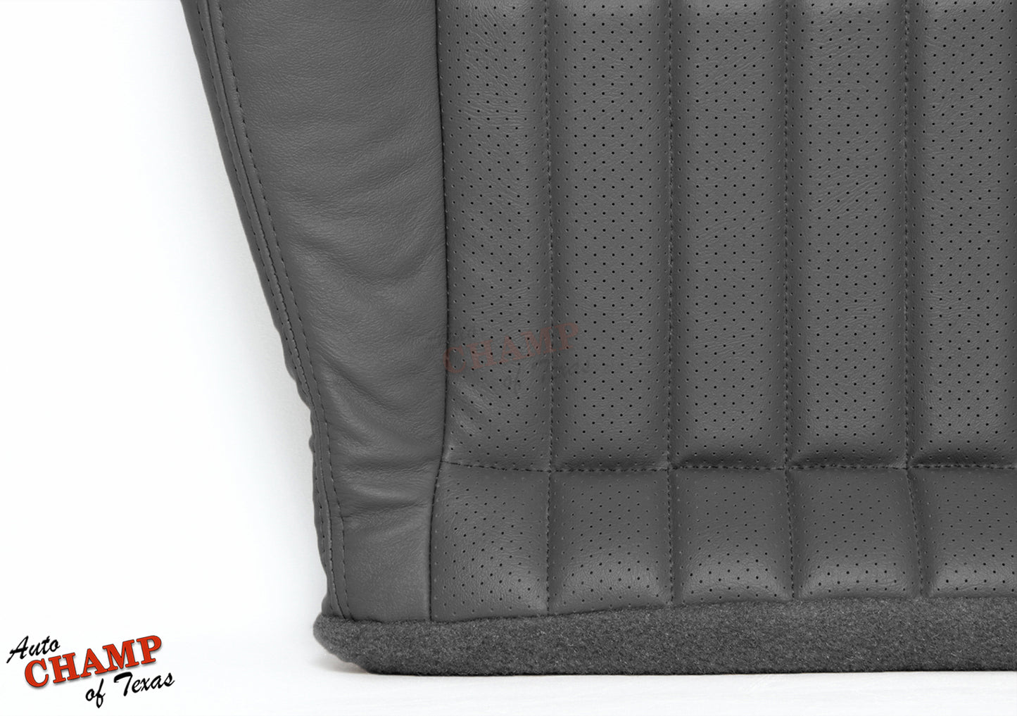 Close-up view of gray perforated leather seat cover stitching and texture.