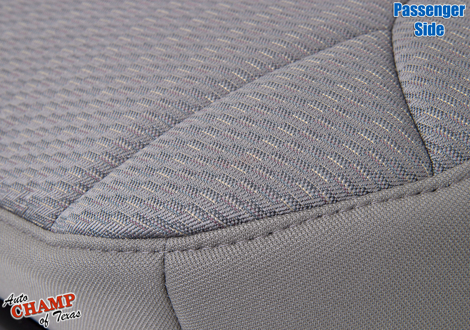 Close-up view of the passenger side bottom cloth seat cover for 2002-2004 Jeep Liberty in taupe.