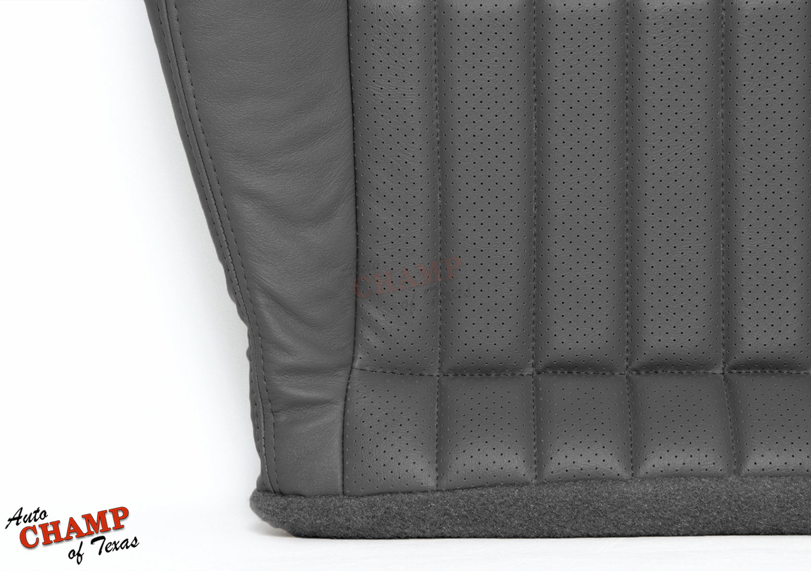 Close-up view of gray perforated leather seat cover stitching and texture.